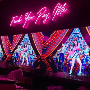 a neon sign that says feel you pay me