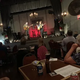 Tables and stage. A great intimate, live music experience.