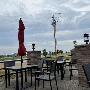 a patio with tables and umbrellas