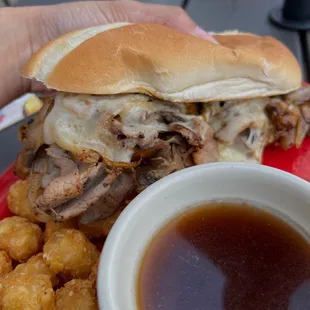 a hand holding a plate of food