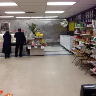 two people standing in front of a refrigerator