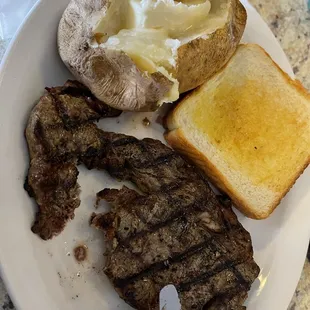Ribeye steak with baked potato and Texas toast
