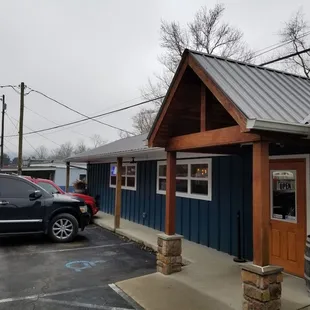 a man standing outside of a restaurant