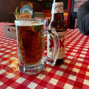 a glass of beer and a bottle on a table