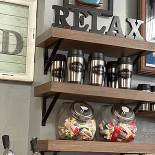 a shelf of coffee cups and mugs