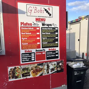  a red food truck with menus