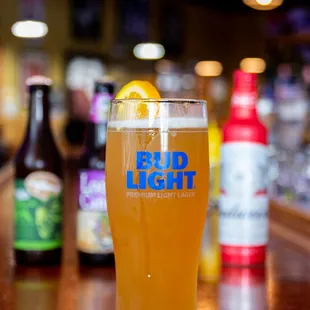 a glass of beer on a bar