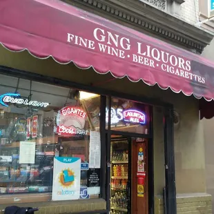 a bicycle parked in front of a wine shop