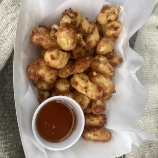 Cheese curds with dipping sauce.