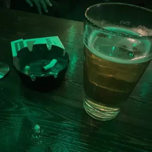 a glass of beer and cigarettes