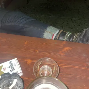 a person sitting at a table with a glass of beer