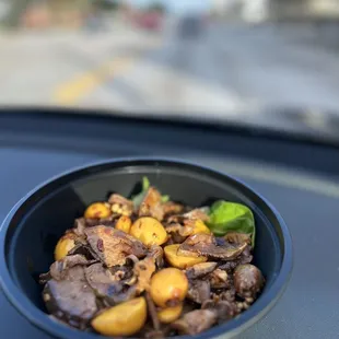 a bowl of food on the dashboard of a car