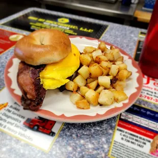 Bacon, Egg, &amp; Cheese Bagel with a side of breakfast potatoes