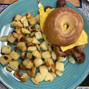 Bacon, egg, and cheese on a toasted bagel with side of home fries