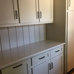 a kitchen with white cabinets