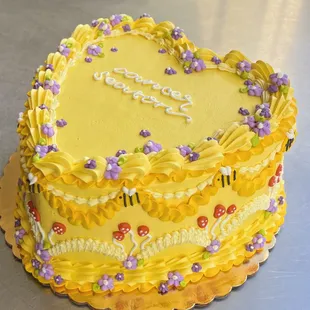 a yellow heart shaped cake
