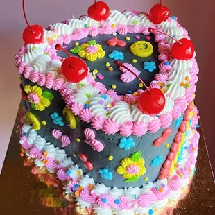 a hand holding a birthday cake