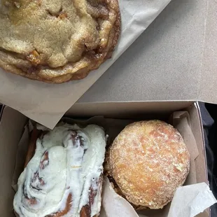 Peanut butter toffee cookie, cinnamon roll and a cereal donut stuffed with cream cheese