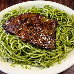 Green fettuccini with steak.