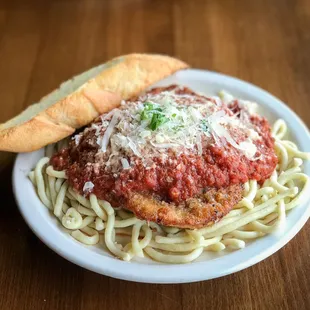 Chicken Parmesan. Hand-breaded with our walnut, garlic and parmesan breading, baked and served over handmade spaghetti with marinara.