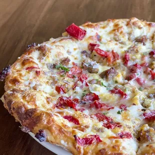 Breakfast Pizza: Alfredo sauce, mozzarella cheese, scrambled eggs, roasted red bell peppers and Italian sausage. Served on Sundays 11-2.