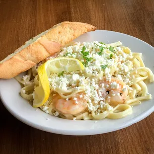 Shrimp Scampi: shrimp baked in garlic lemon butter and white wine, tossed with handmade linguine and topped with feta cheese.