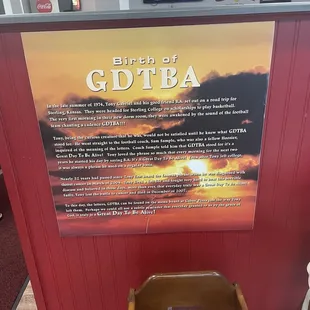 a wooden chair in front of a sign