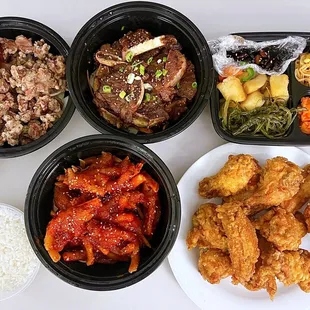 Clockwise: L.A. Galbi ($34.99), Banchan, KFC ($25.99), Dakbal - chicken feet ($19.99), Dak Dong Jjip - chicken gizzard &quot;stir-fry&quot; ($14.99)