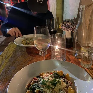 a plate of pasta and a glass of wine