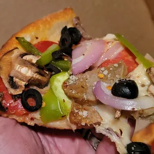 Slice of Supreme pizza