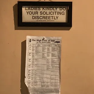 a sign that reads ladies kindly do your soliciting directly