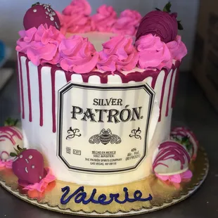 a cake decorated with a silver patron label
