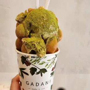 a person holding a cup of ice cream