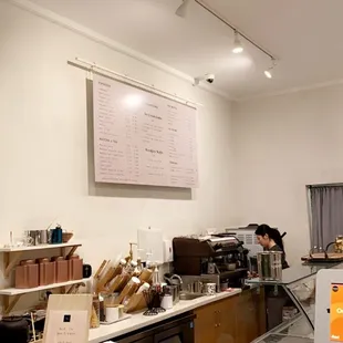 a coffee shop with a counter and shelves