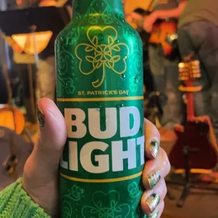 a person holding a bottle of irish beer