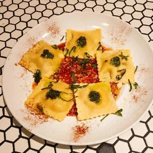 a plate of ravioli with sauce