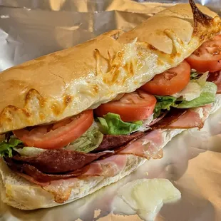 a sub sandwich with tomatoes and lettuce