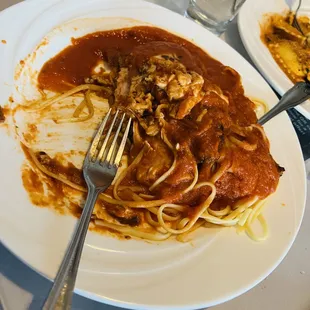 a plate of spaghetti with meat and sauce