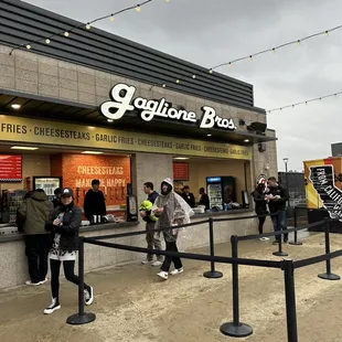 a group of people standing outside of a store