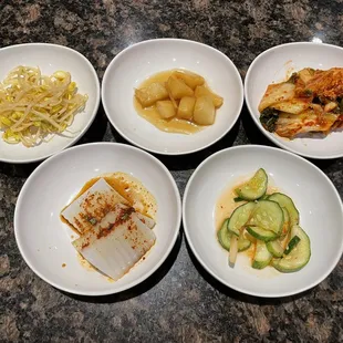 Banchan (Side Dishes) - marinated bean sprout, potatoes, kimchi, acorn jelly, and cucumbers