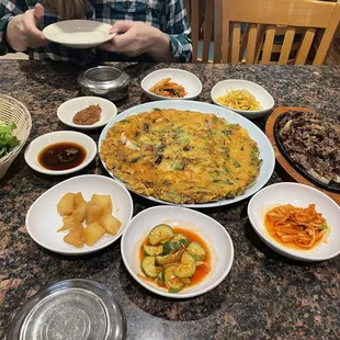 Beef bulgogi, seafood pancake, and different types of kimchi.