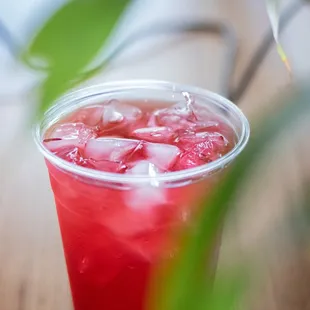 a red drink with ice cubes