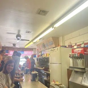 a group of people sitting at a counter