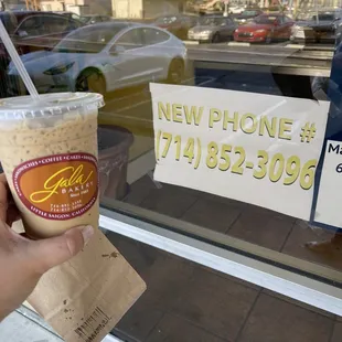 a hand holding a cup of coffee