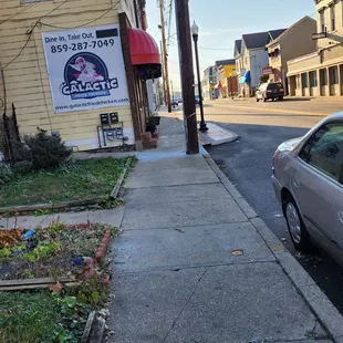 Sidewalk view with front yards of homes pictured