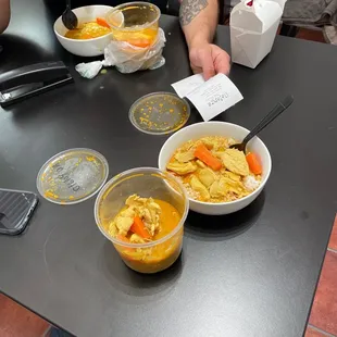 a man sitting at a table with bowls of food