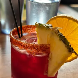 a cocktail with a pineapple garnish
