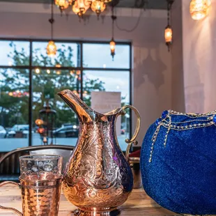 a blue purse and a blue purse on a wooden table