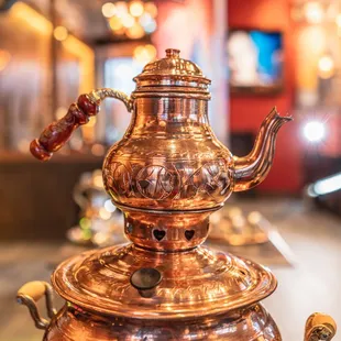 a copper teapot on a table