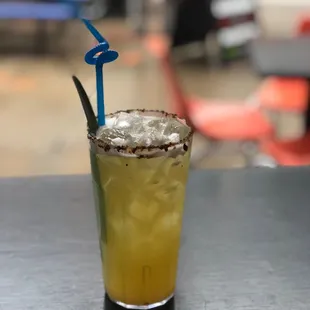 a glass with a drink on a table